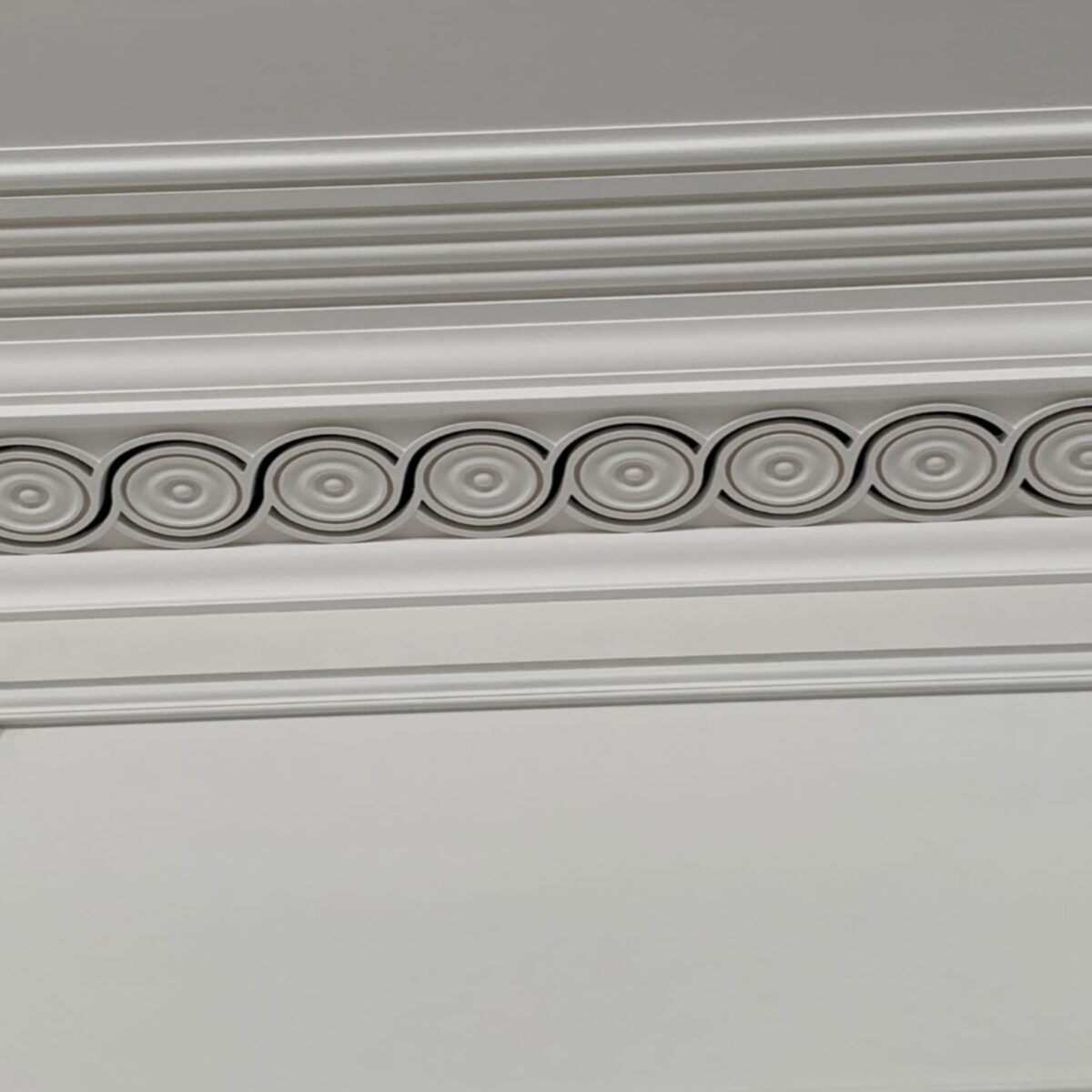 Decorative plaster cornice with integrated air ventilation holes, combining traditional moulding with modern functionality