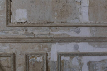 Close-up of a sympathetically repaired internal wall showcasing traditional lime plaster repairs blending seamlessly with original fabric. Heritage-led restoration in accordance with SPAB and Historic England conservation guidelines, ideal for architects specifying materials and methods for listed building repairs.