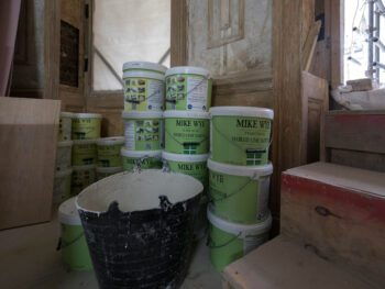 Stacks of lime plaster materials on site, ready for heritage restoration work.