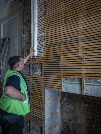 Close-up of a heritage-trained artisan using traditional lime plaster methods to restore decorative cornices and mouldings on the Grade II listed at Portland Place in London. Specialist conservation work in line with Historic England and SPAB principles, ensuring sustainable restoration of classical architectural elements for architects focused on responsible heritage design.
